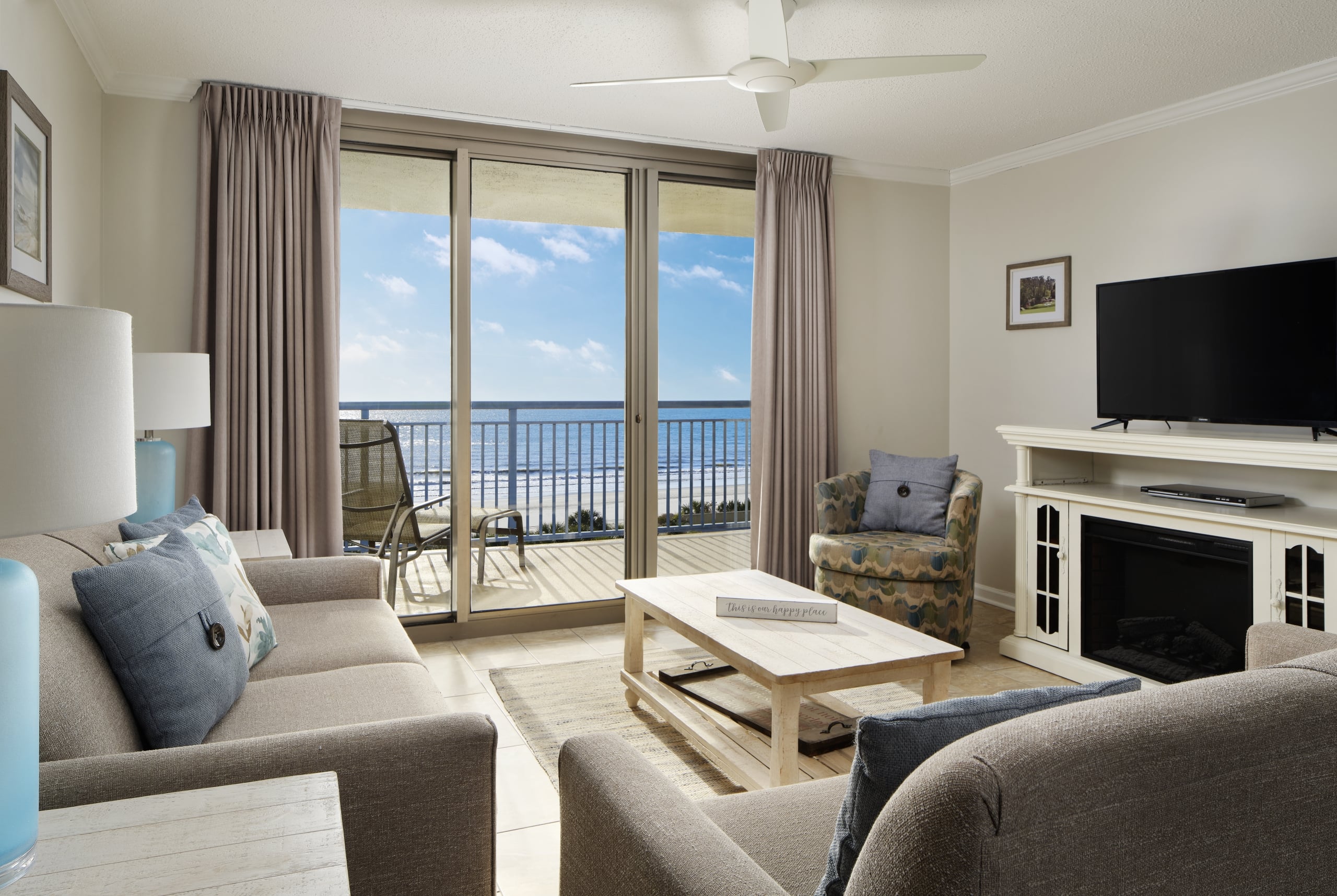 Brighton condo living room with balcony access and an ocean view