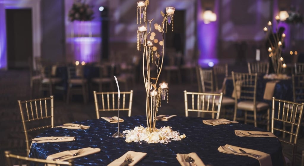 Hilton Ballroom wedding table setup with gold and dark blue features