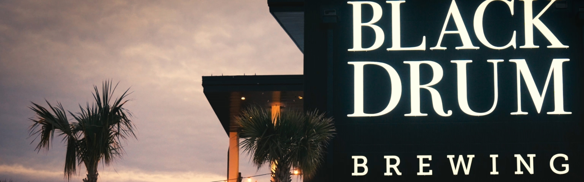 Black Drum Brewing exterior at night with the lights on