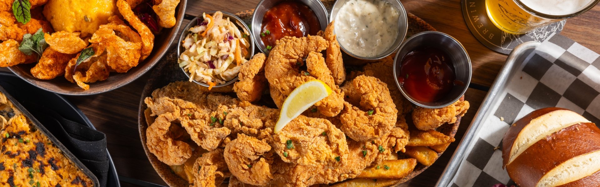 Spread of Black Drum Brewing food and a beer on the table